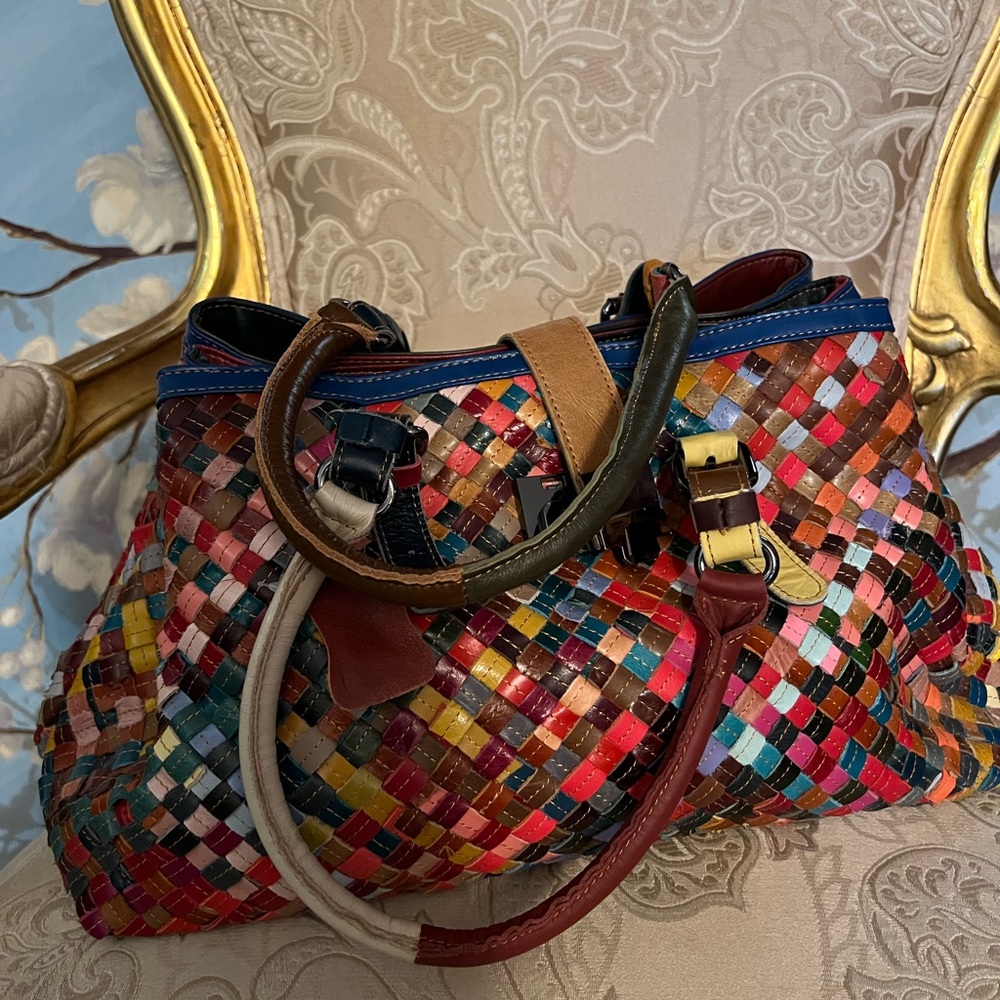 Leather hand bag with multiple colors. New.